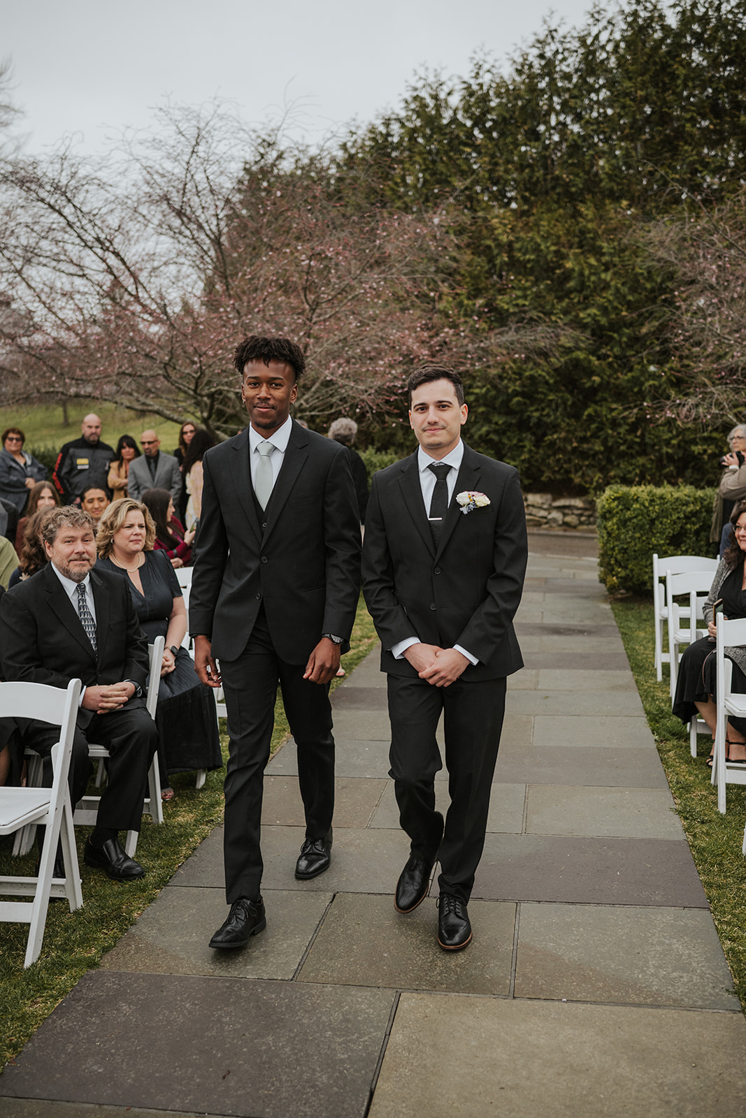 Groom and best man processional walking down the ceremony aisle at the start of the ceremony.