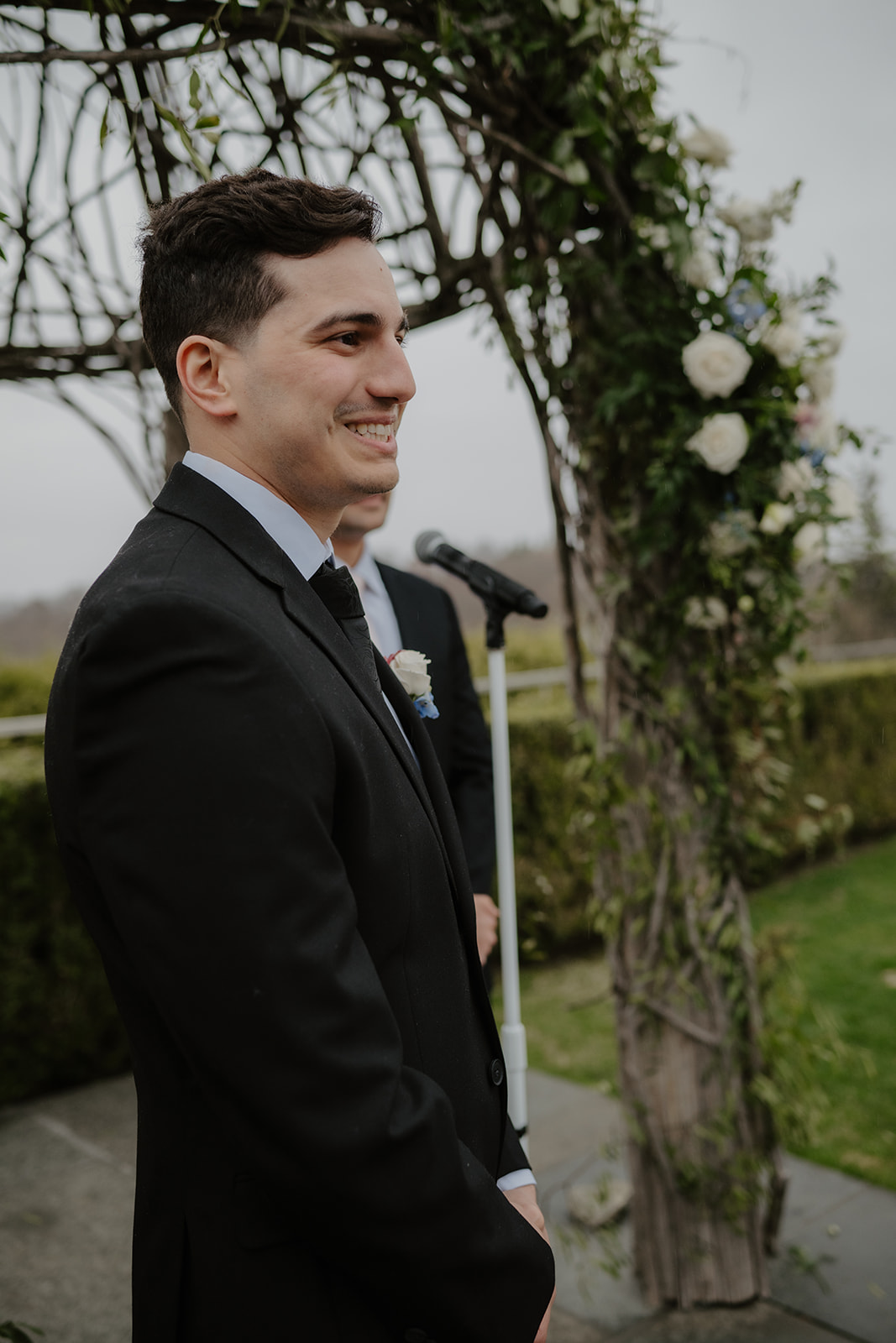 Groom's emotional reaction with tears as he watches the bride approach the altar.